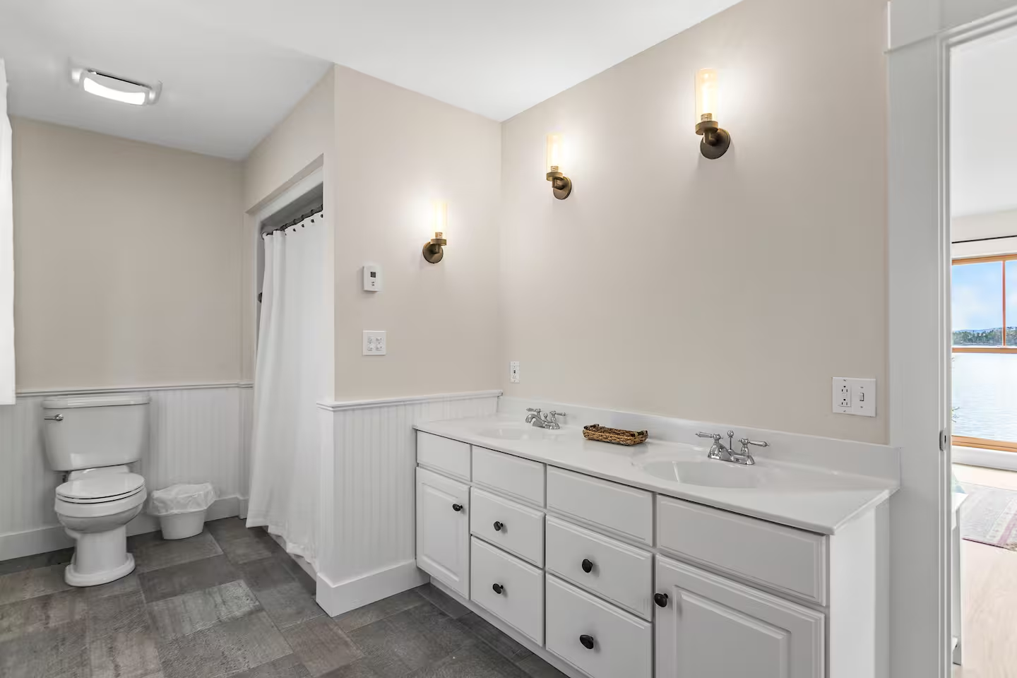 Bathroom with double vanity and bay view